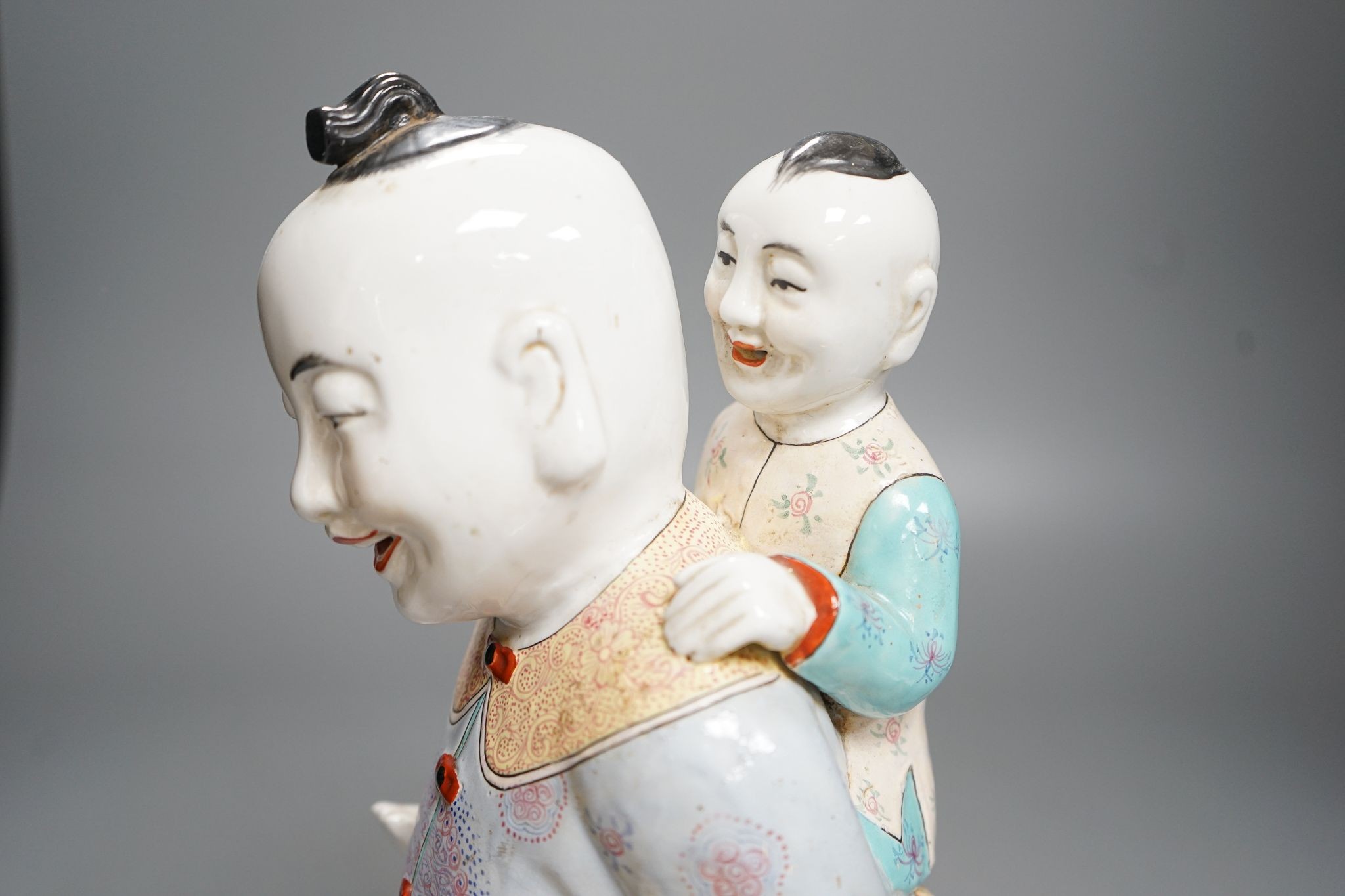A large Chinese enamelled porcelain boys group, 31cm